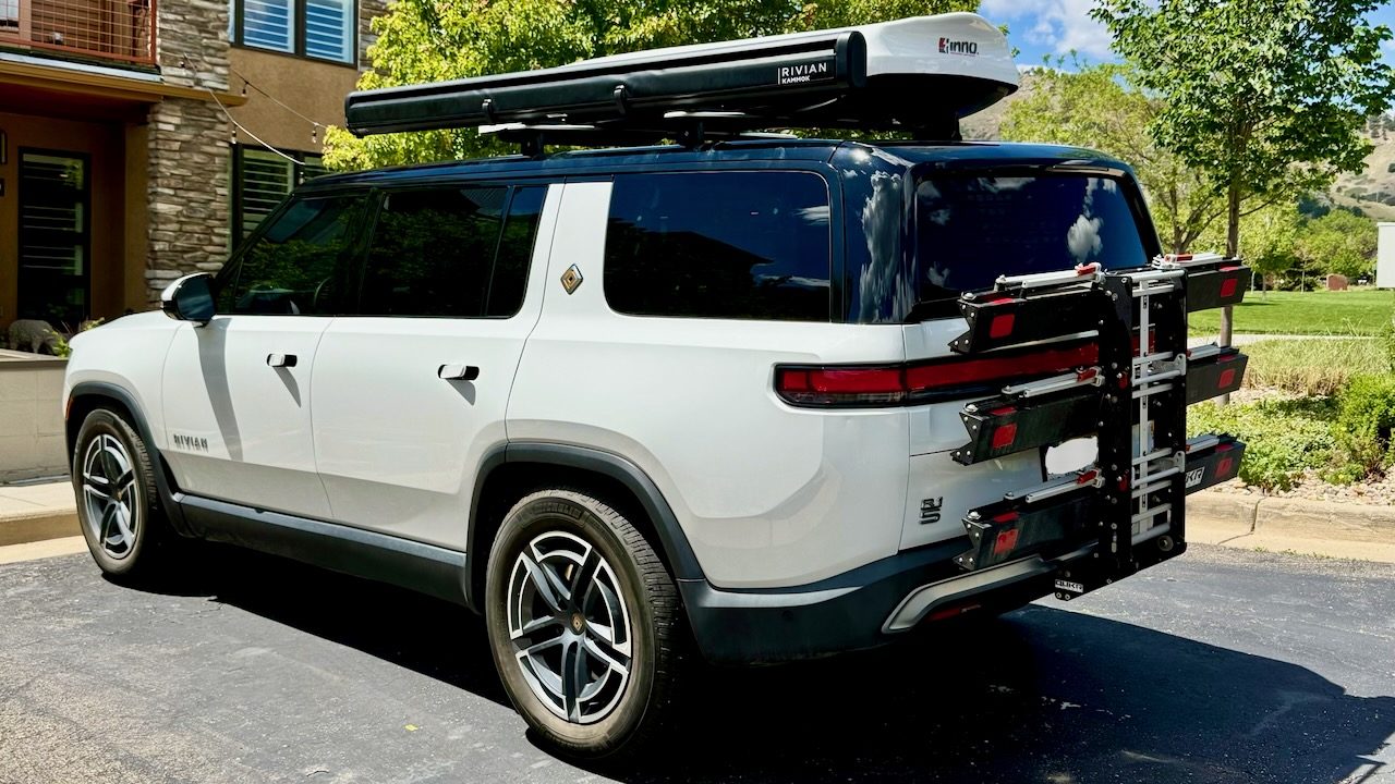 Our Rivian packed for the trip, with a roof box and a rack on the back