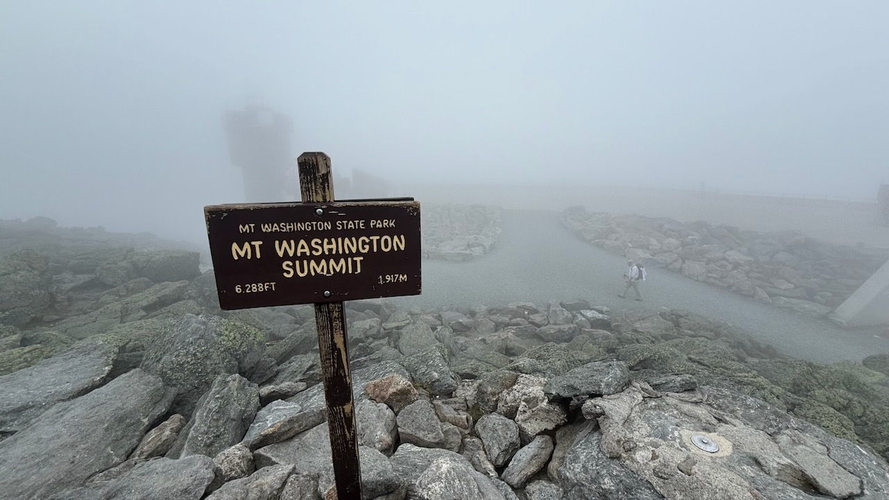 The Mount Washington summit sign, briefly inside a cloud