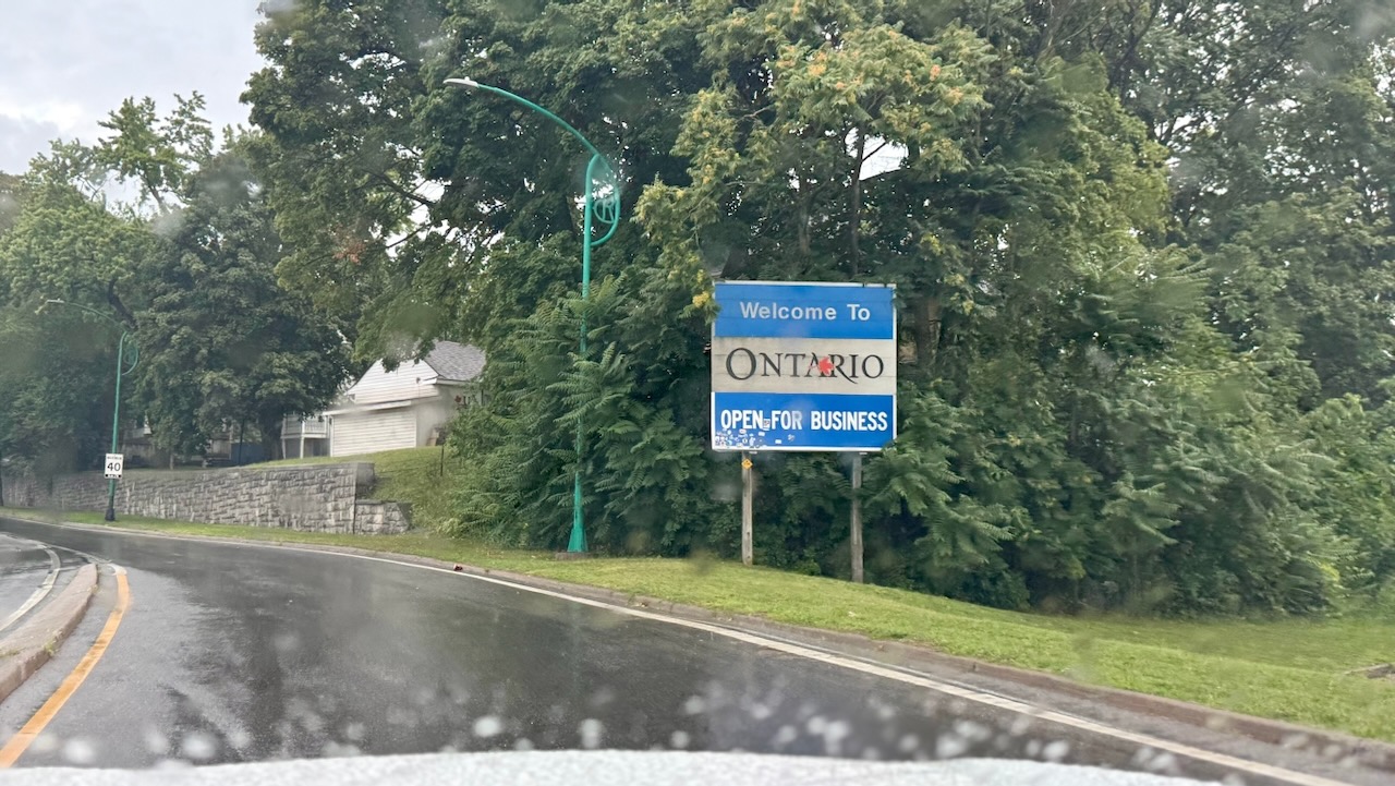 Welcome to Ontario sign in the rain, on a brief pass through Canada